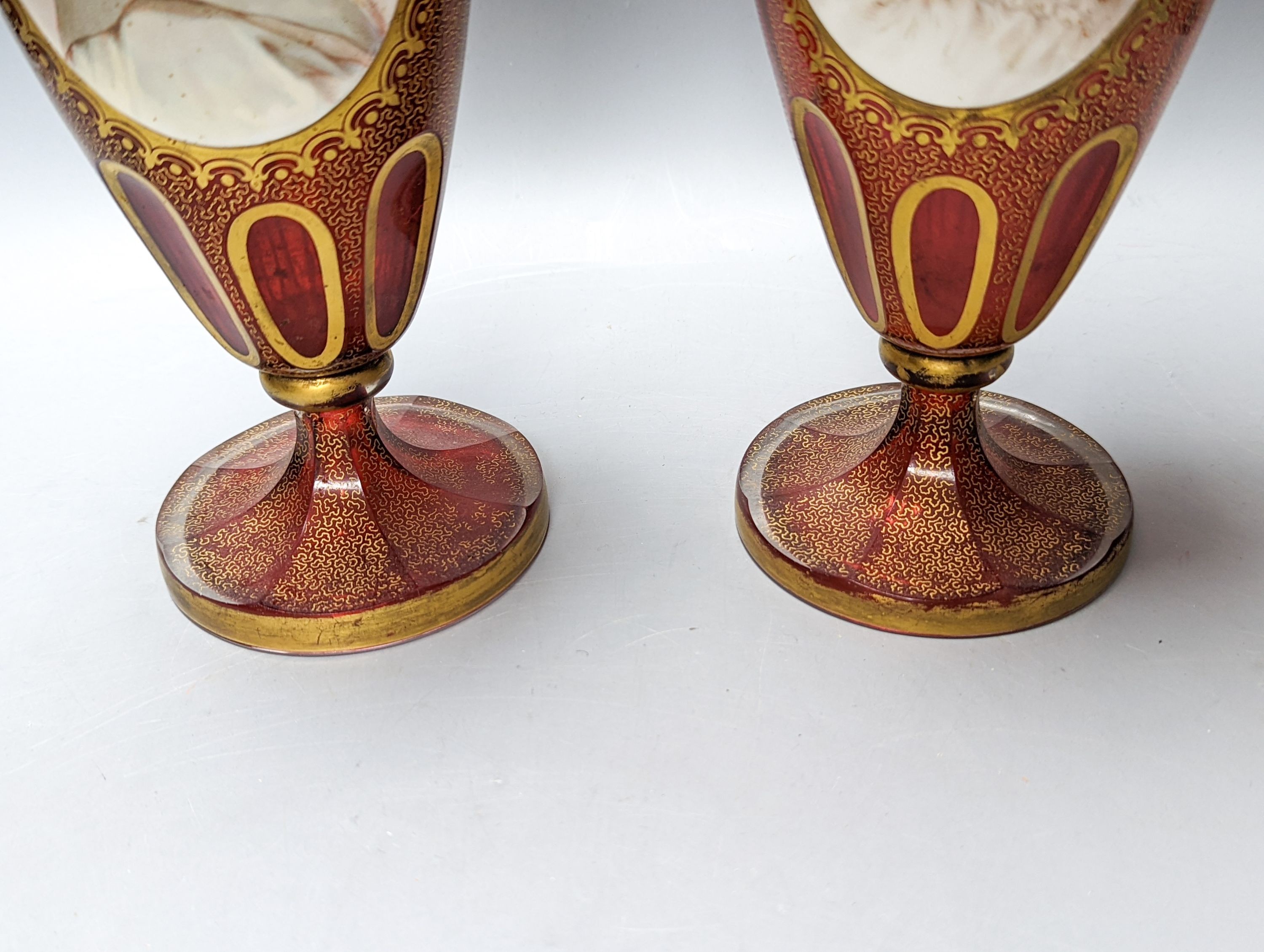 A pair of Bohemian enamelled and overlaid cranberry glass vases, 19th century 35cm